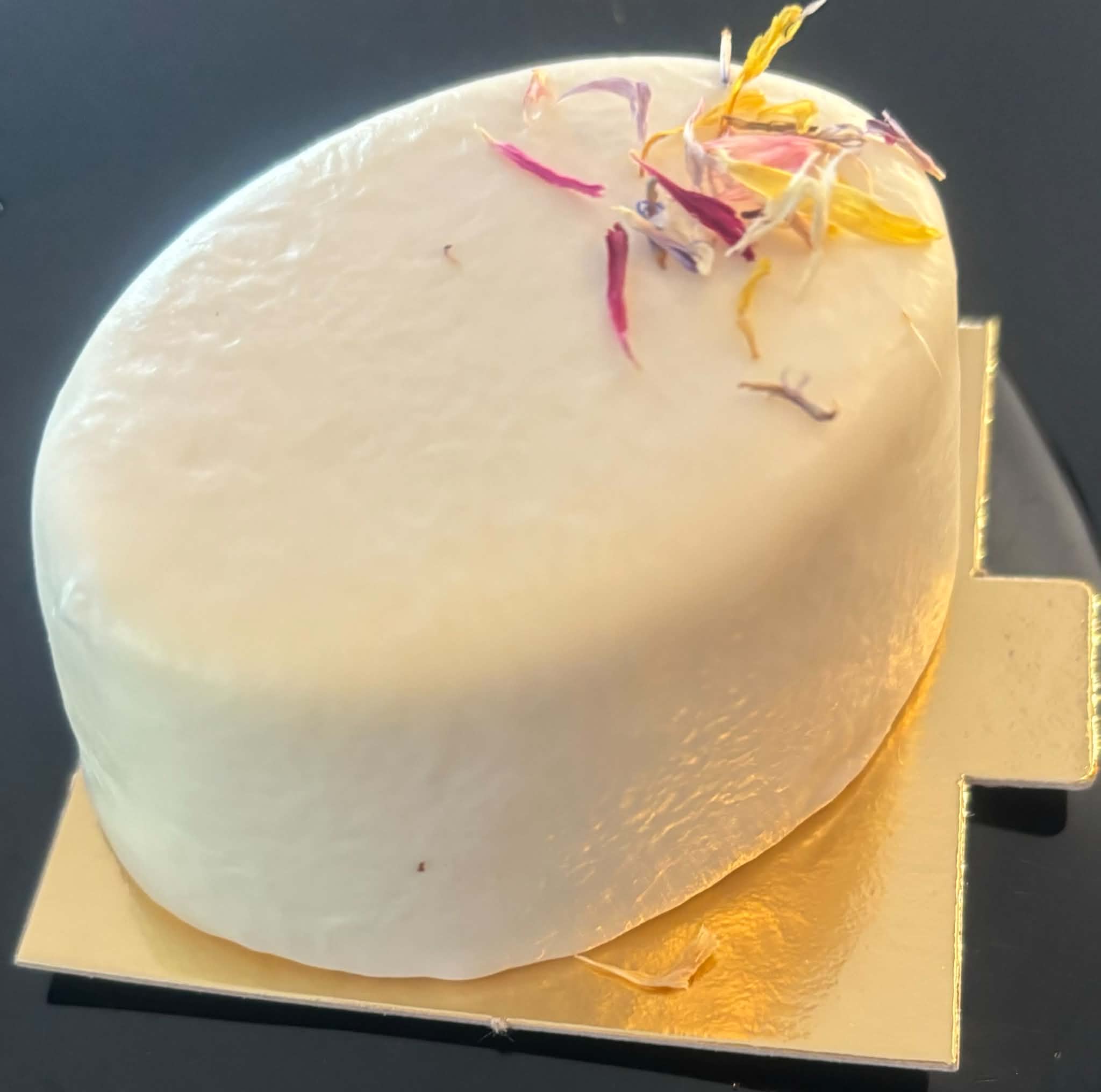 Fehér bevonatú gluténmentes torta ehető virágszirmokkal